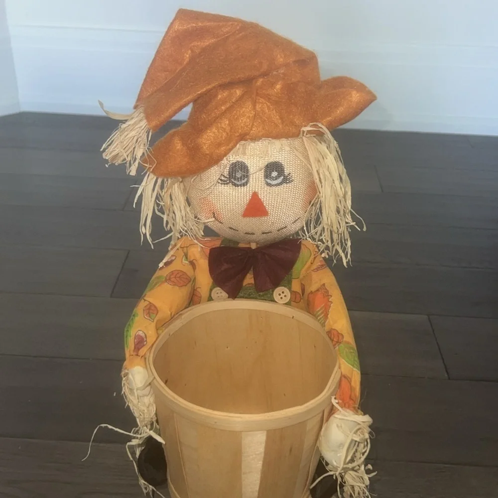 Scarecrow figurine with straw Bale